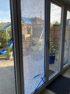 Broken window on White UPVC Door