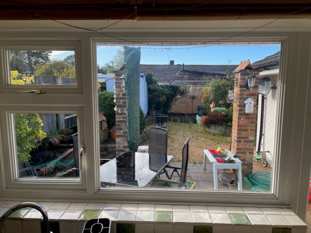 window replacement with white frame overlooking garden